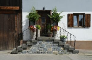 brown wooden door in front of bricked stairs