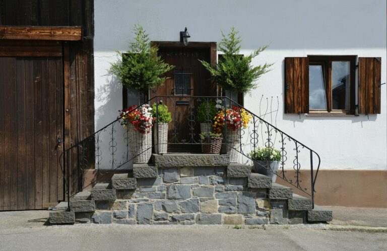 brown wooden door in front of bricked stairs